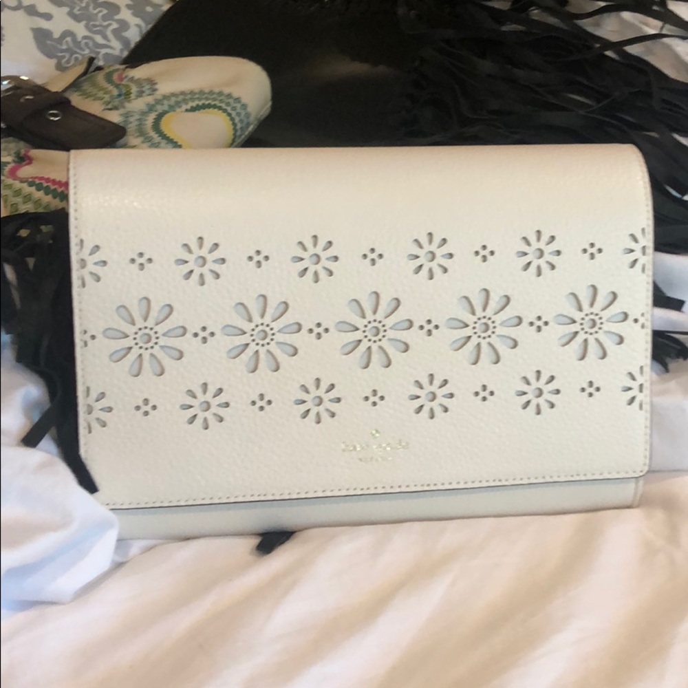 Kate Spade never used white/ivory colored clutch.